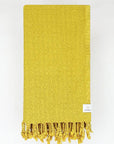 Folded towel in plain mustard colour.